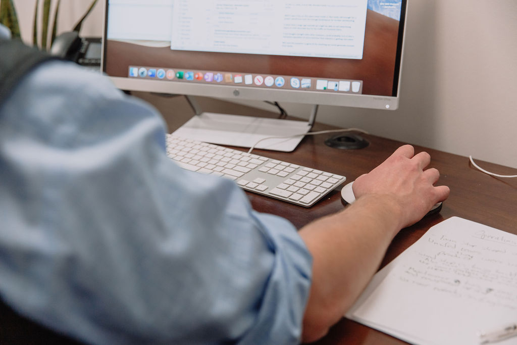 Person working on computer sitting at a desk