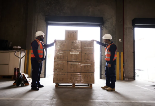 Workers organizing boxes in a warehouse environment